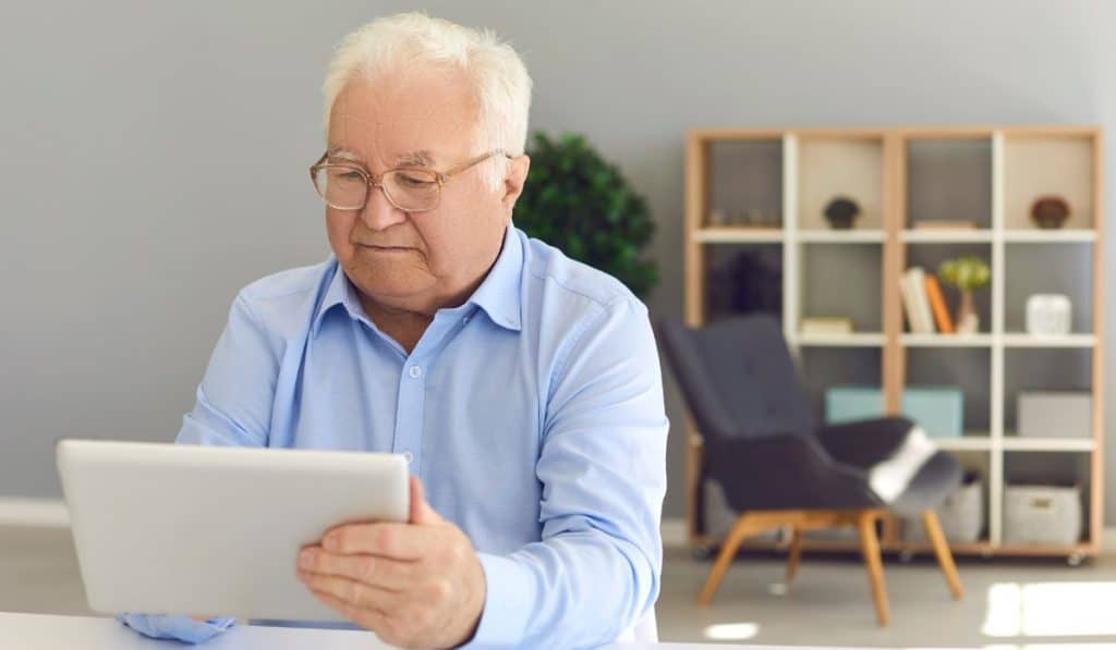 elderly man having an online therapy appointment