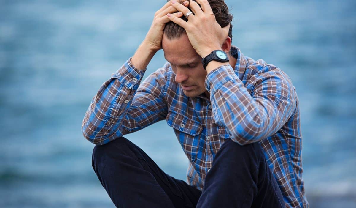man sitting outside depressed
