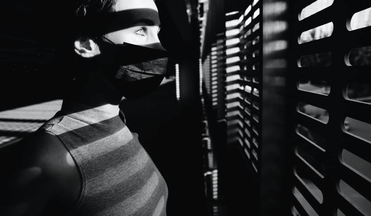 person looking outside in the dark