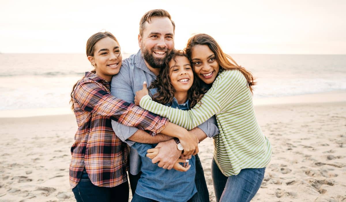 family and teen on the beach